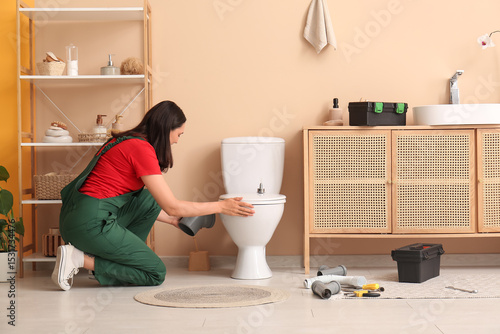 Female plumber installing t...
