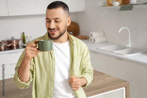 Young man with ceramic cup ...