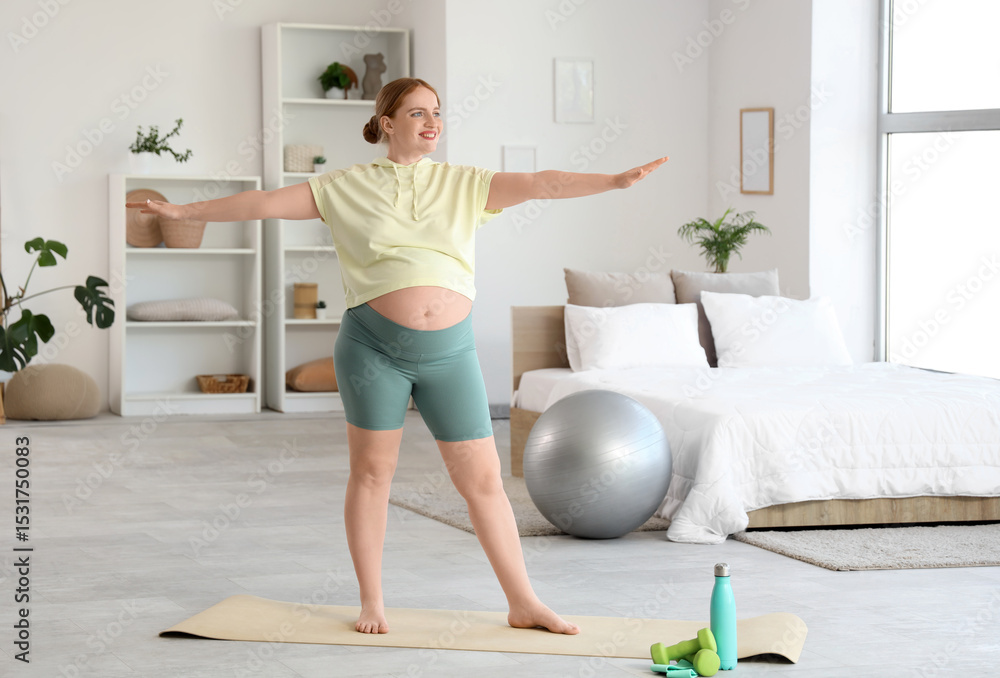 Fototapeta premium Sporty pregnant woman training in bedroom
