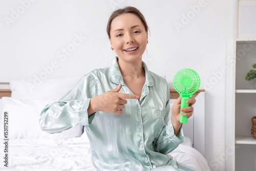 Young woman pointing at min...