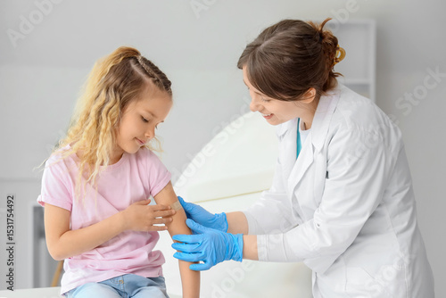 Female doctor applying patc...