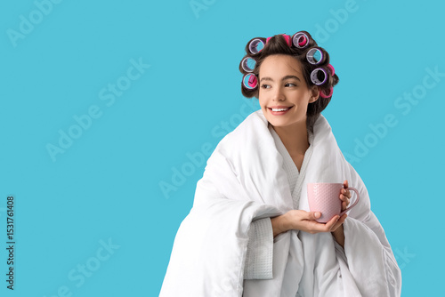 Young woman in blanket with...