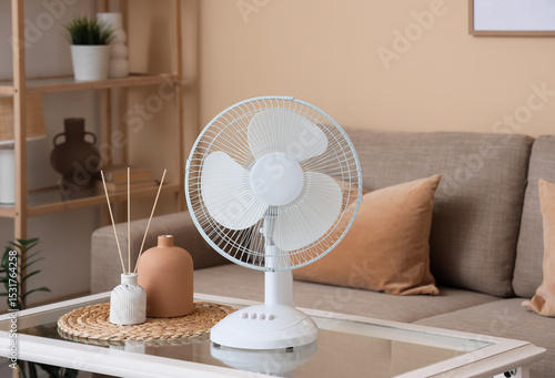 Electric fan on table near ...