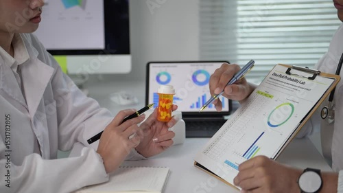 Two doctors are looking at a chart