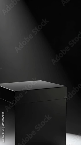 Elegant black box with lid on spotlight stage, minimalist presentation platform on dark background, sleek modern geometric container