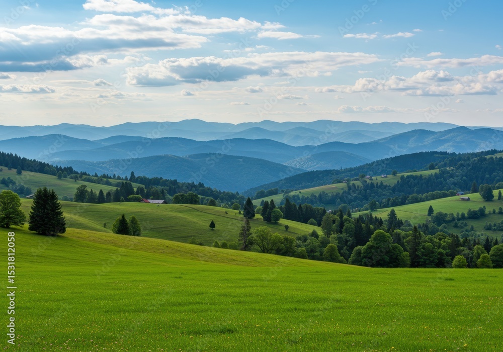 Rolling green hills and mountains under a bright summer sky Rolling green hills and mountains under a bright summer sky