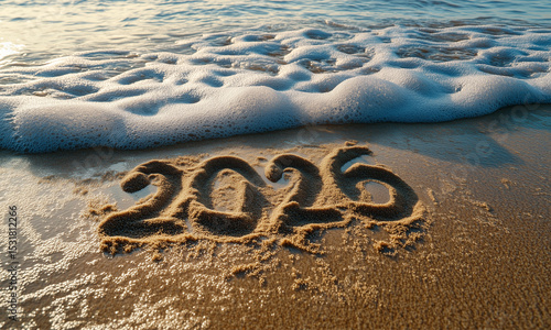 2026 number written in sand on a beach, symbolising celebration, new year concept