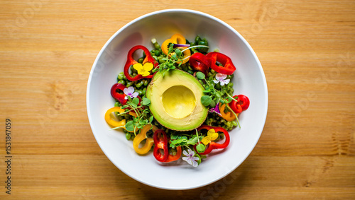 Vibrant Green Pea Avocado Bowl with Red and Yellow Bell Pepper Slices Edible Flowers Microgreens Healthy Food Dish Top View