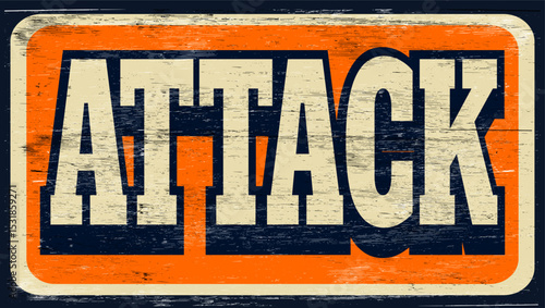 Aged and worn attack sign on wood