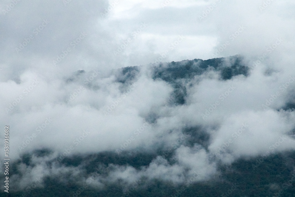 Fototapeta premium high and steep mountain surrounded by heavy clouds at chiang mai Northern Thailand