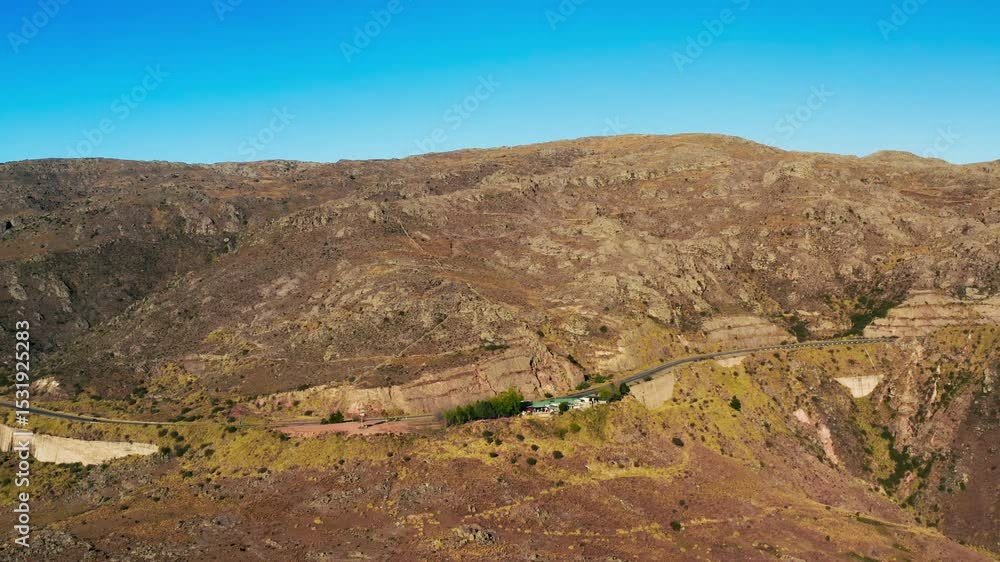 Mountainous landscape with a winding road and clear blue skies in Cordoba, Argentina Mountainous landscape with a winding road and clear blue skies in Cordoba, Argentina