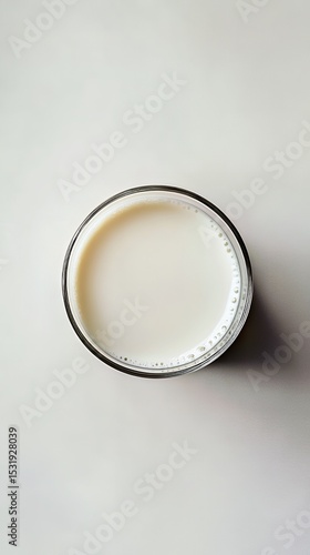 Wallpaper Mural A clear glass filled with fresh milk, captured from a top-down perspective. Torontodigital.ca