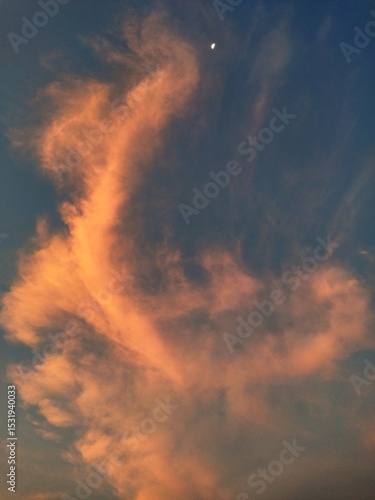The mysterious evening sky features orange cloud formations in the shape of six