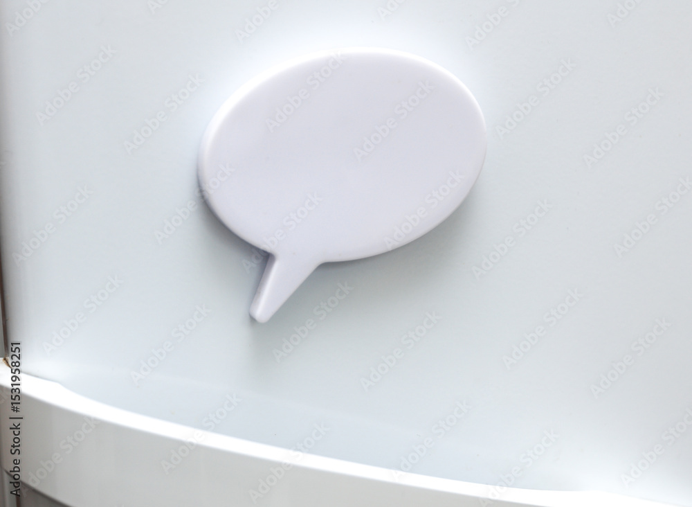 White magnet in the form of a dialog cloud for notes and reminders on the refrigerator door White magnet in the form of a dialog cloud for notes and reminders on the refrigerator door