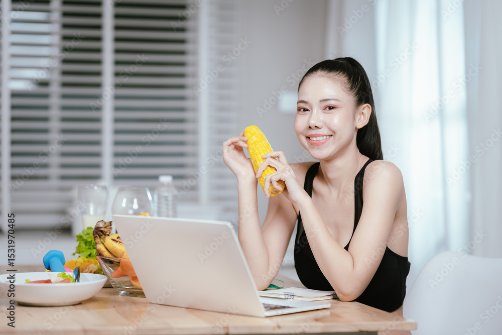 A smiling young woman in activewear holds broccoli while looking at a laptop, promoting healthy eating and digital engagement. A smiling young woman in activewear holds broccoli while looking at a laptop, promoting healthy eating and digital engagement.