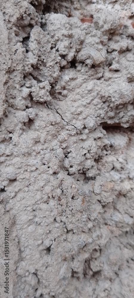 Fototapeta premium Unpainted Wall with Rough Sand Plaster Finish, Grainy and Uneven Cement Surface, Close-Up Texture for Construction or DIY Renovation Backgrounds