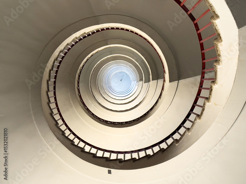 Photos Abstract spiral staircase with minimalist design and red railings