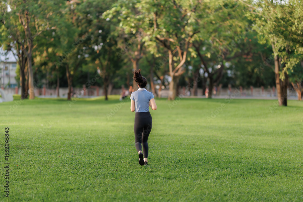 An Asian woman stretches and goes for a run in a public park, embracing outdoor exercise and a healthy lifestyle surrounded by nature. An Asian woman stretches and goes for a run in a public park, embracing outdoor exercise and a healthy lifestyle surrounded by nature.