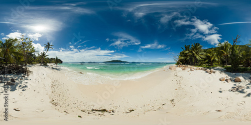 Fototapeta Naklejka Na Ścianę i Meble -  A serene tropical beach with soft white sand and crystal waters, bordered by lush palm trees. Anse grosse rocche beach. La Digue, Seychelles. 360 panorama VR.