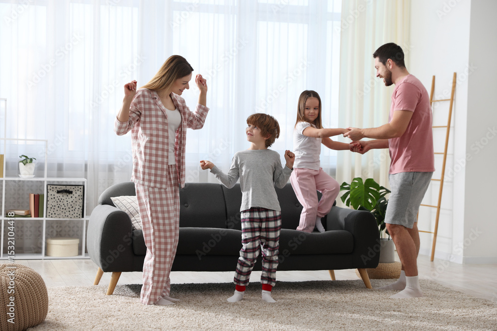 Fototapeta premium Happy family wearing stylish pajamas having fun at home