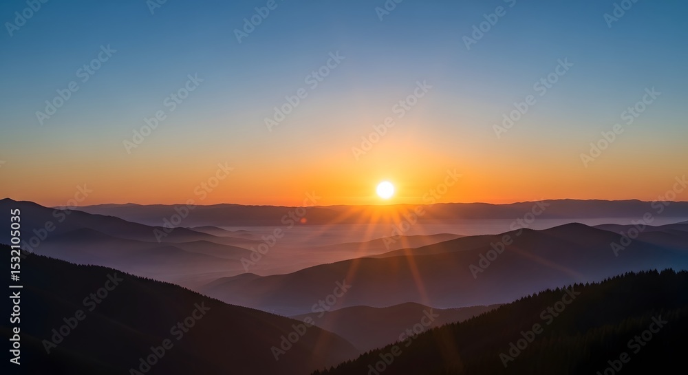 Fototapeta premium Mountain Range at Colorful Sunrise with Fog Rolling Through Valleys