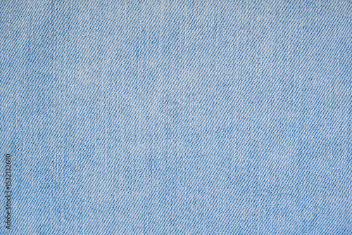 Jeans textile close up. Detail of light blue denim pants.	