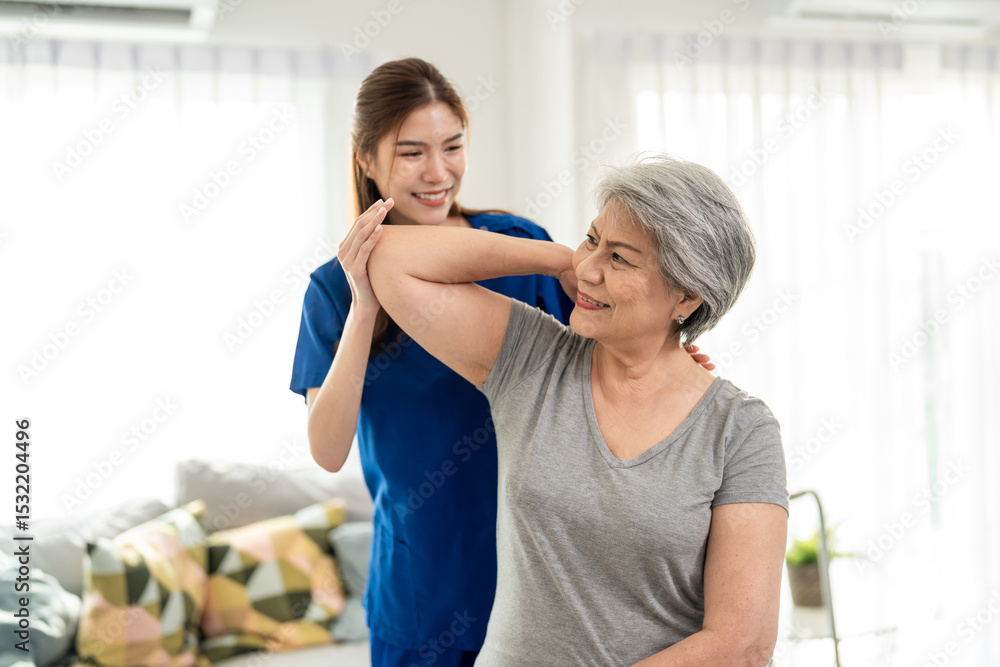 Elderly Asian woman receive physical therapy with support of caregiver. Elderly Asian woman receive physical therapy with support of caregiver.