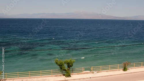 Landscape in Greece with breathtaking coastal views and vibrant blue waters. Perfect spot for travel and tourism. Relax and enjoy tranquil surroundings surrounded by nature.