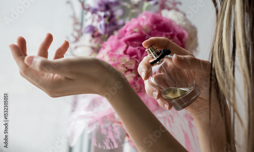 Woman spraying perfume