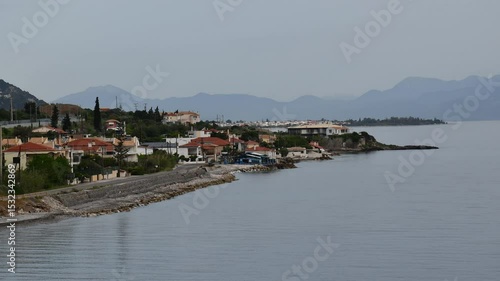 Small coastal village in Greece time lapse landscape. Greek sea coast with small village and traditional Greek houses. Travel destination in Europe