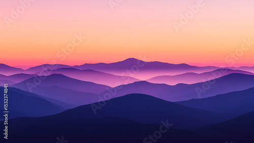 Beautiful layered mountains with an orange and pink sunset backdrop in the sky.