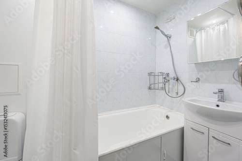 Wallpaper Mural Clean bathroom with tub, shower, sink and mirror. White and light blue tones Torontodigital.ca