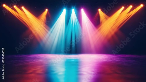Colorful stage lights shine brightly on reflective floor with orange, blue, and purple beams illuminating dark space, spotlight creating vibrant atmosphere and dynamic light reflections.