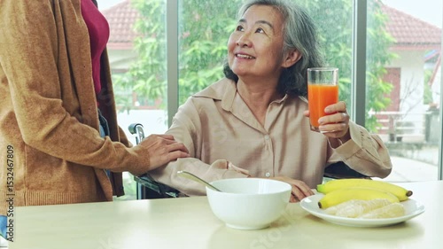 The eldest daughter who takes care of her elderly mother with food and nutrition for her mother's good health.