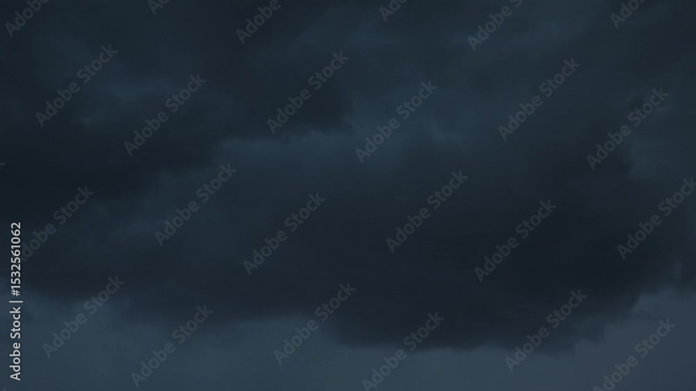 Dark storm clouds gather over the horizon at dusk in a tranquil landscape Dark storm clouds gather over the horizon at dusk in a tranquil landscape