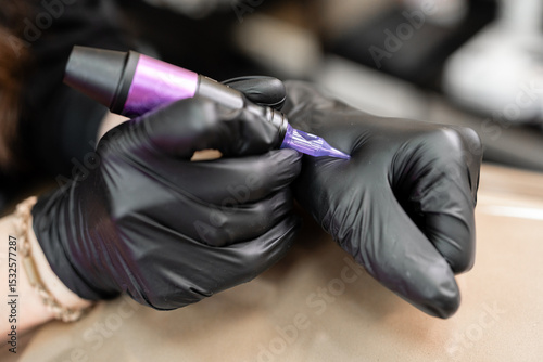 Professional Hands Applying Permanent Makeup with Machine
