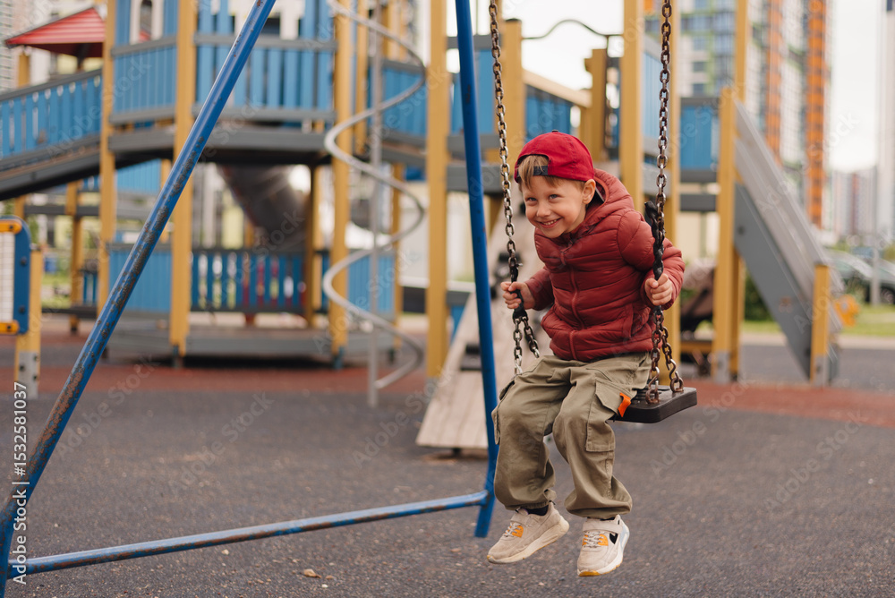Obraz premium Child enjoys swinging on playground in urban area during sunny day, showcasing happiness and playfulness