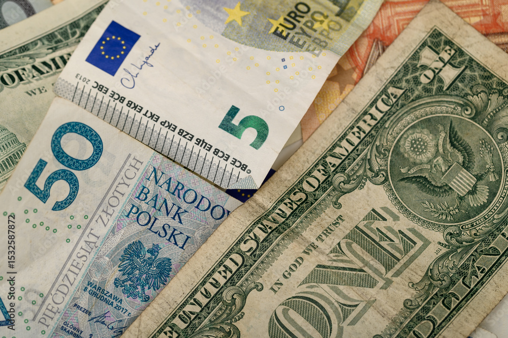 Obraz premium Paper banknotes of various countries of America, the European Union, and Poland close up