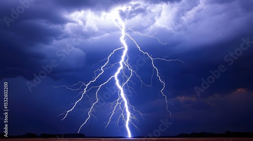Fototapeta Naklejka Na Ścianę i Meble -  Powerful lightning bolt striking dark clouds.