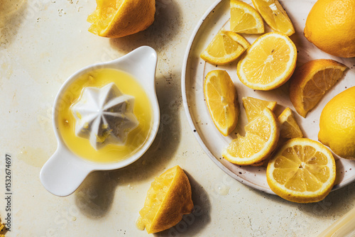 Juiced and sliced lemons with ceramic citrus juicer on table.jpg