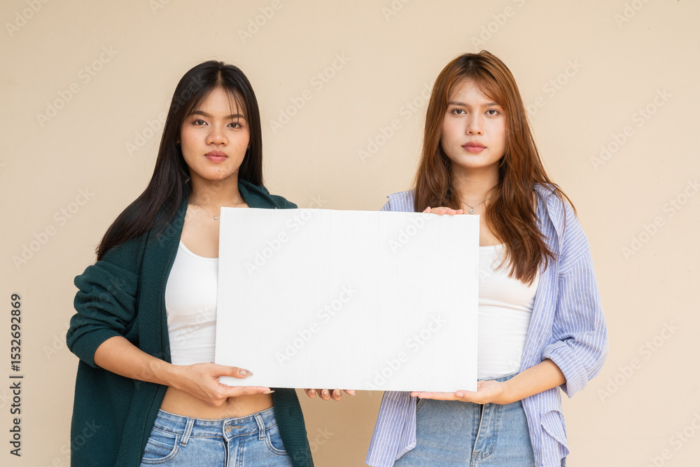two young women holding blank placard two young women holding blank placard