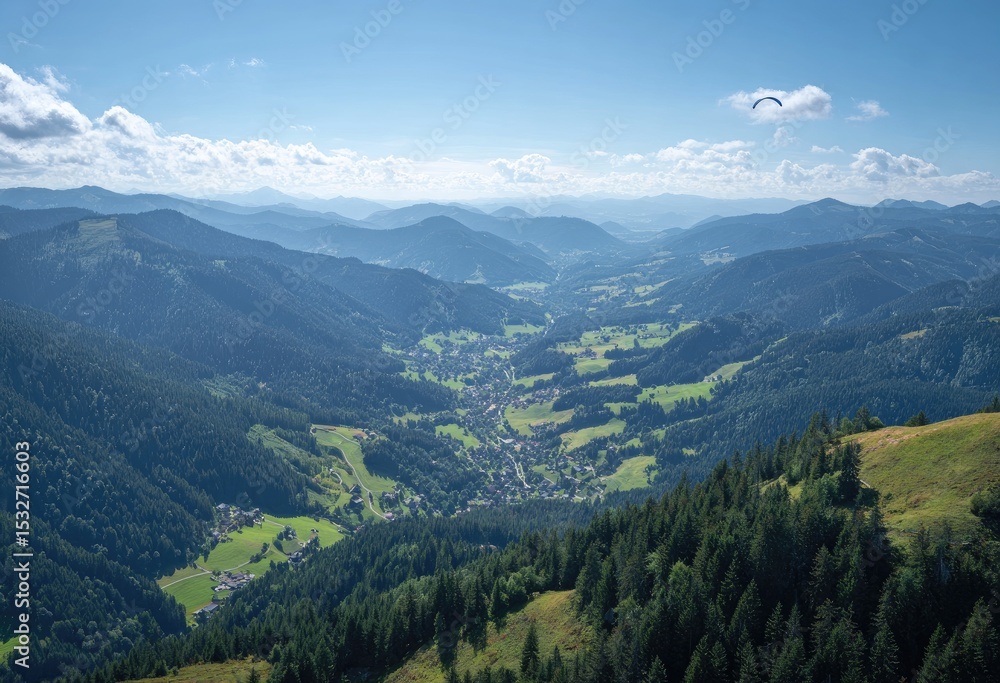 Panoramic view of a valley nestled between lush green mountains, a paraglider soaring high above Panoramic view of a valley nestled between lush green mountains, a paraglider soaring high above