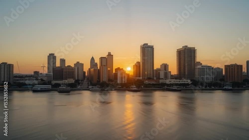 Wallpaper Mural Stunning Sunrise Over City Skyline Reflecting on Calm Waters with Boats at Dusk Torontodigital.ca