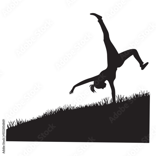 Silhouette of a girl doing a cartwheel in grass
