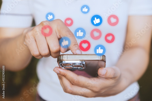 Woman checks smart phone mobile for likes and hearts in social media. Social network sharing and commenting in the online community, Holding phone and using application social media with icon heart