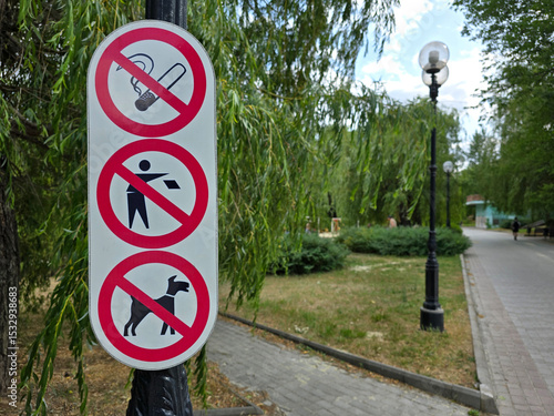 Informational notice no smoking, no littering, no dogs on a summer day in the park. Stop pollution. Protection of nature. Social rules