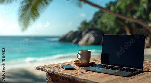 Laptop, coffee cup and smartphone on a wooden table with a tropical beach in the background, representing the work from home concept