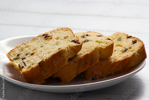 Slices of Traditional Sweet Fruit Bread on Wooden Board