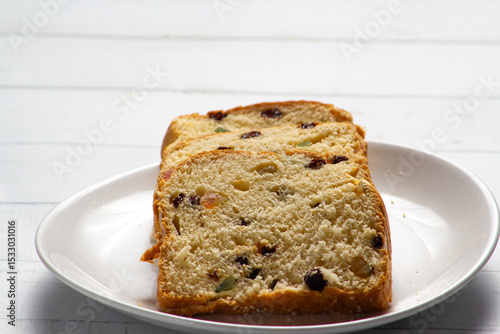 Slices of Traditional Sweet Fruit Bread on Wooden Board