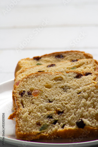 Slices of Traditional Sweet Fruit Bread on Wooden Board